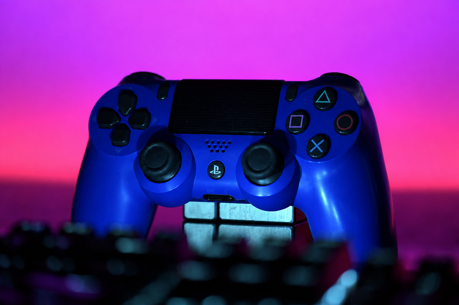 A game controller resting on a keyboard, representing the RAM and CPU competition between a browser and a game running at the same time
